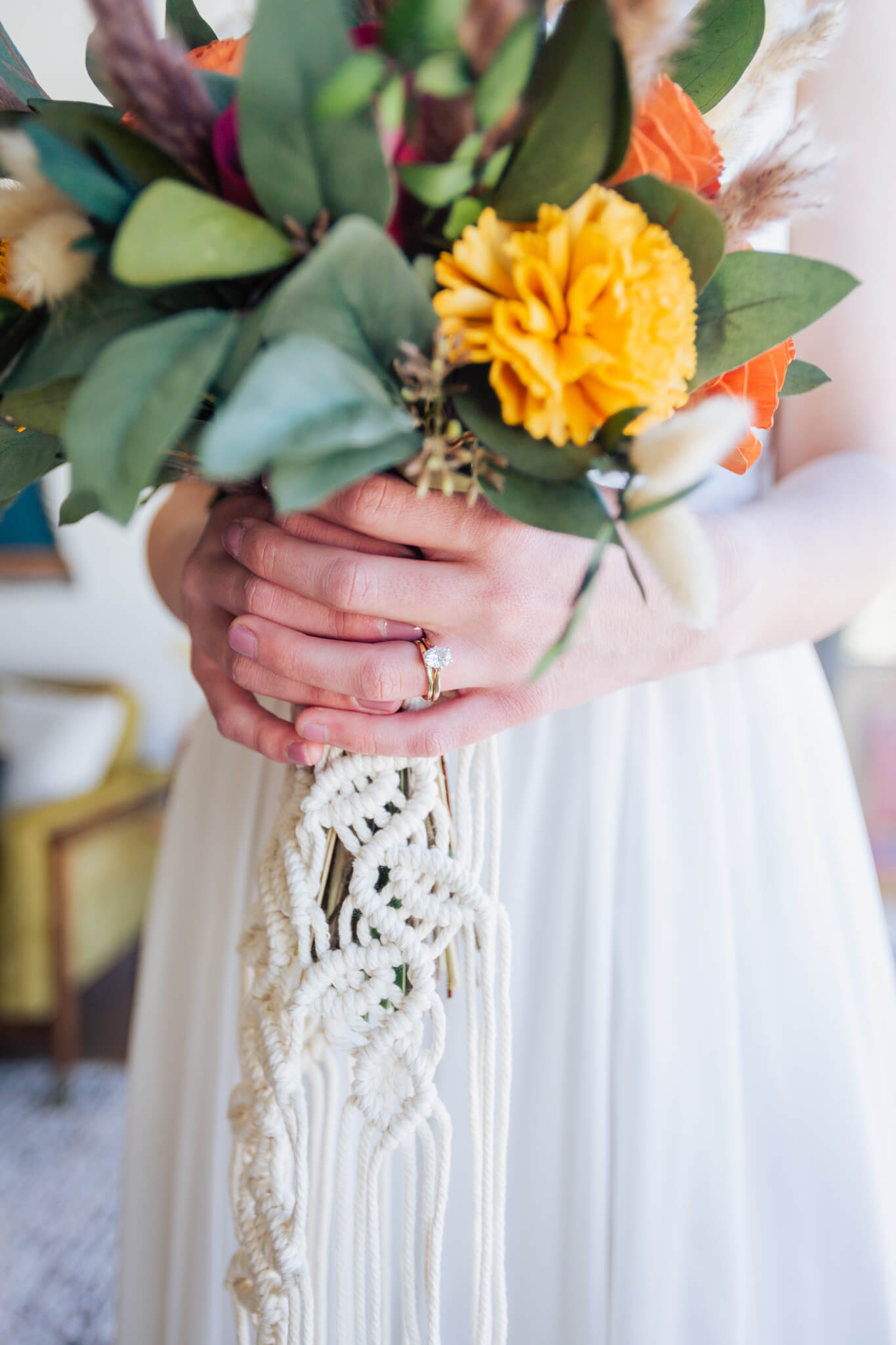 Close-up of the bride's ring and bouquet.