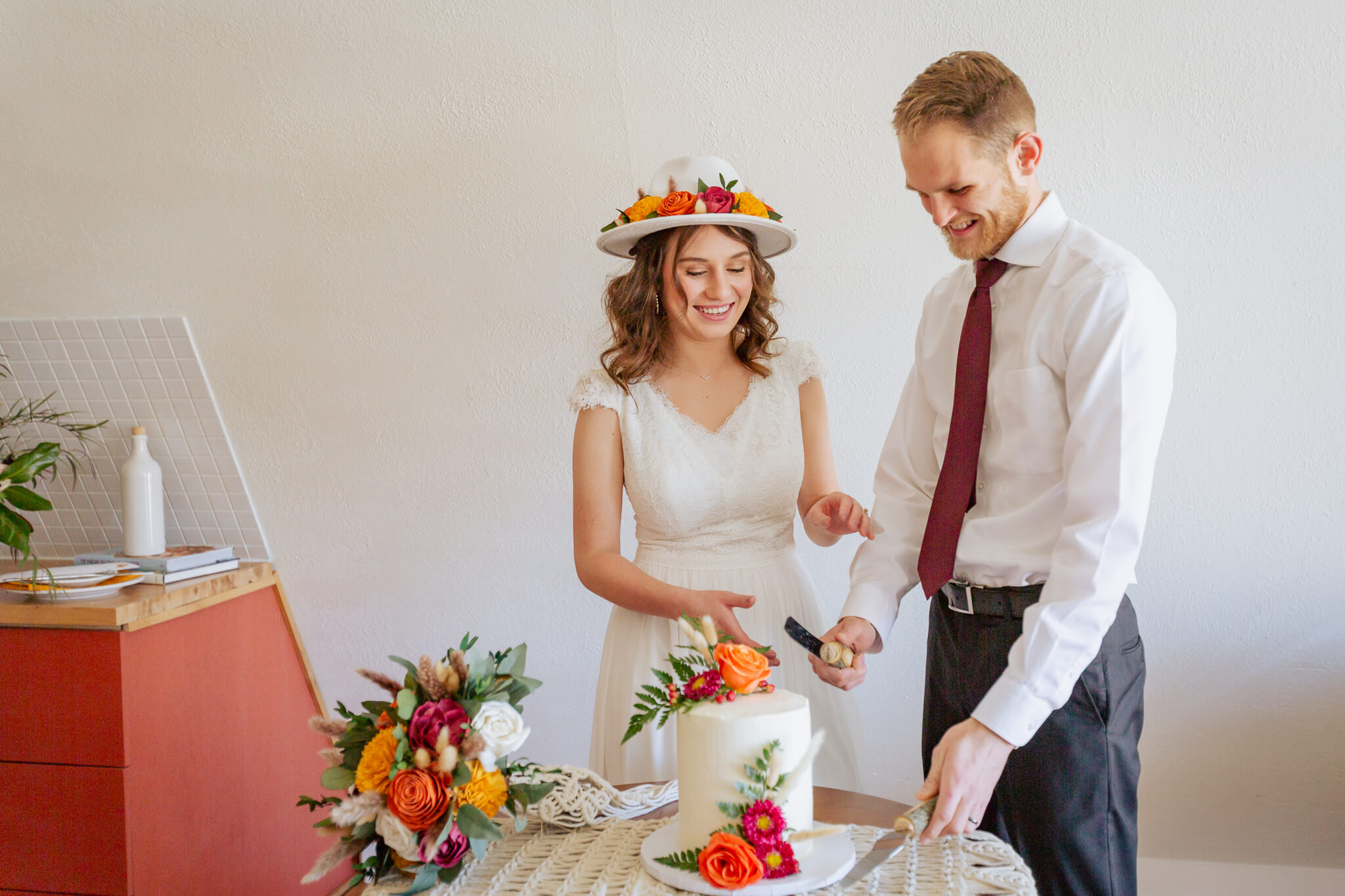 Couple about to cut a slice of wedding cake.