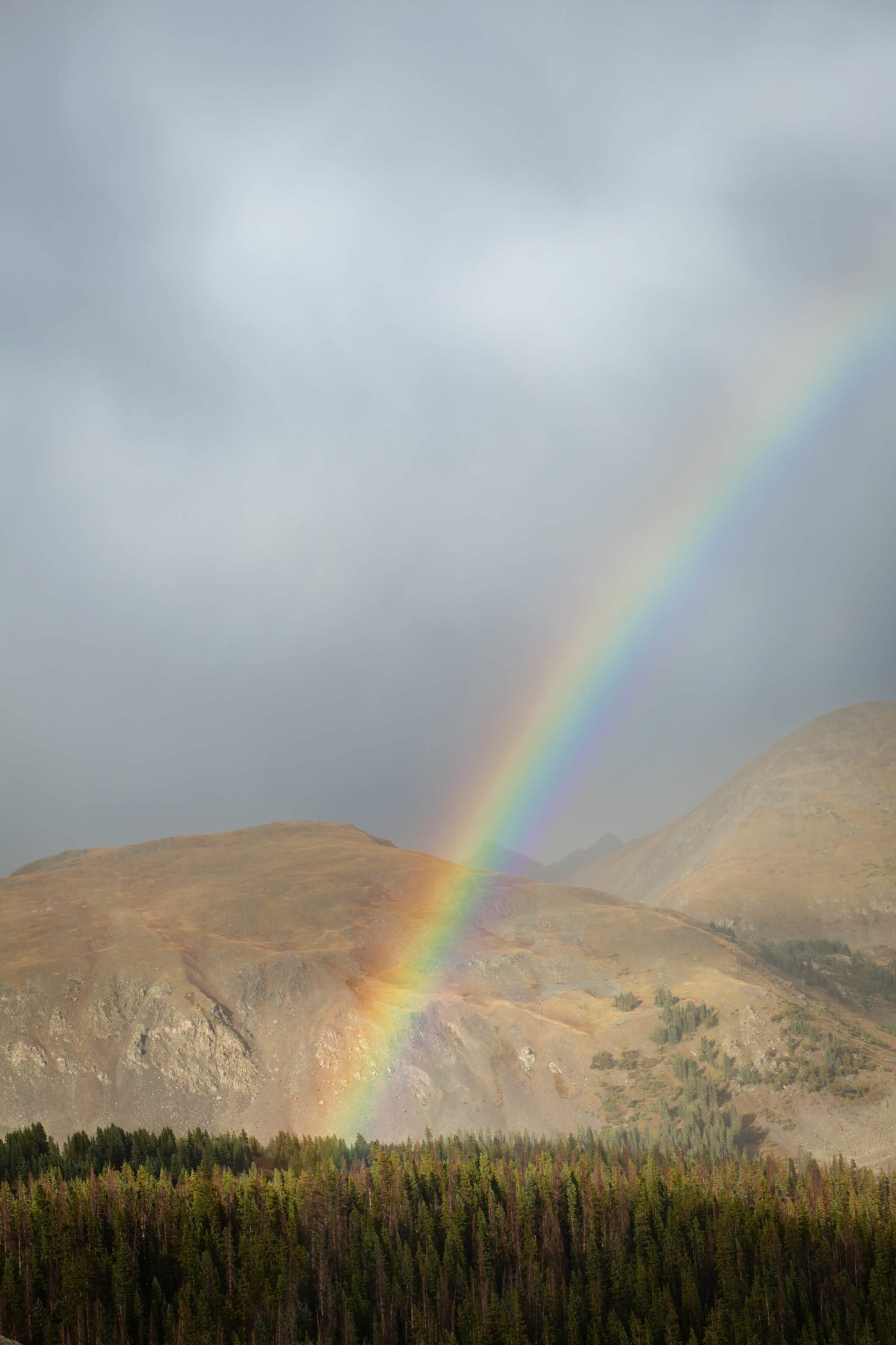 image of rainbow gliding over the mounrains