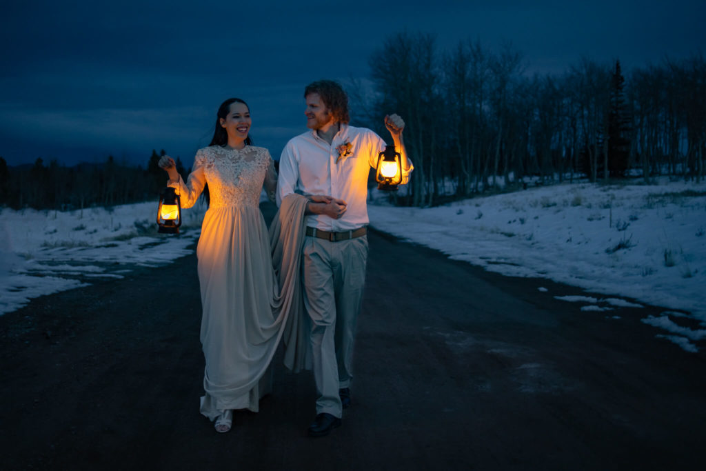 couple walking with lanterns in colorado