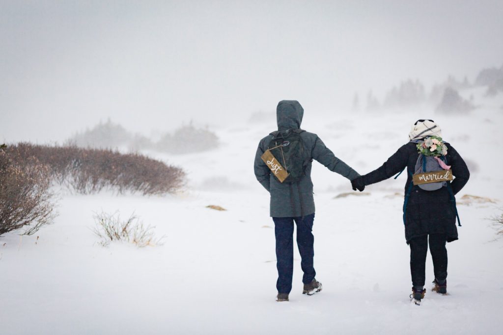 The couple bundled up in their cold gear holding hands.