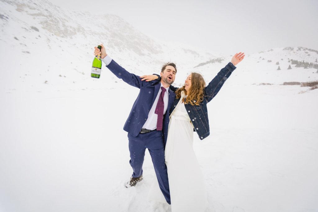 The newlywed couple celebrated their winter elopement with champagne.