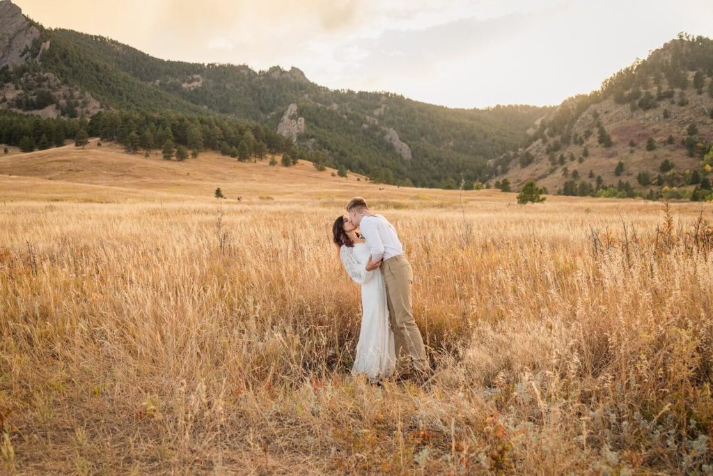 bride and groom kissing in a valley in Boulder Colorado