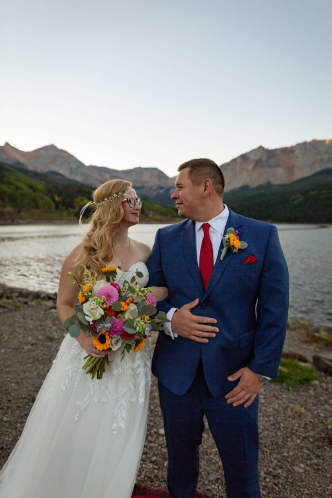 bride and groom looking at each other in front of the Telluride mountain range