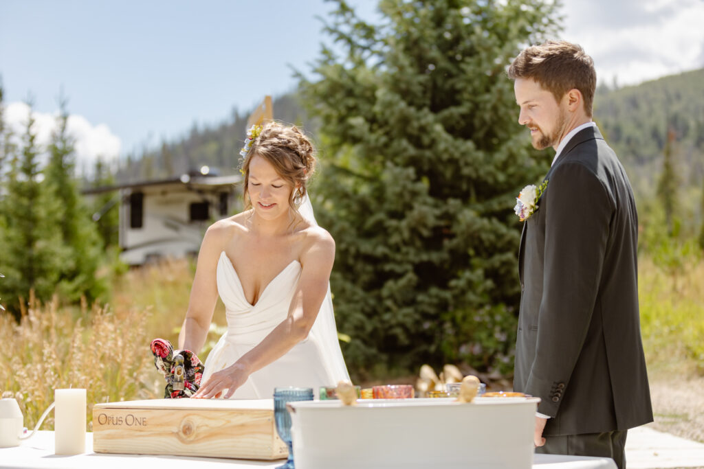 Bride and groom hammer shut a time capsule as part of their elopement ceremony in steamboat springs