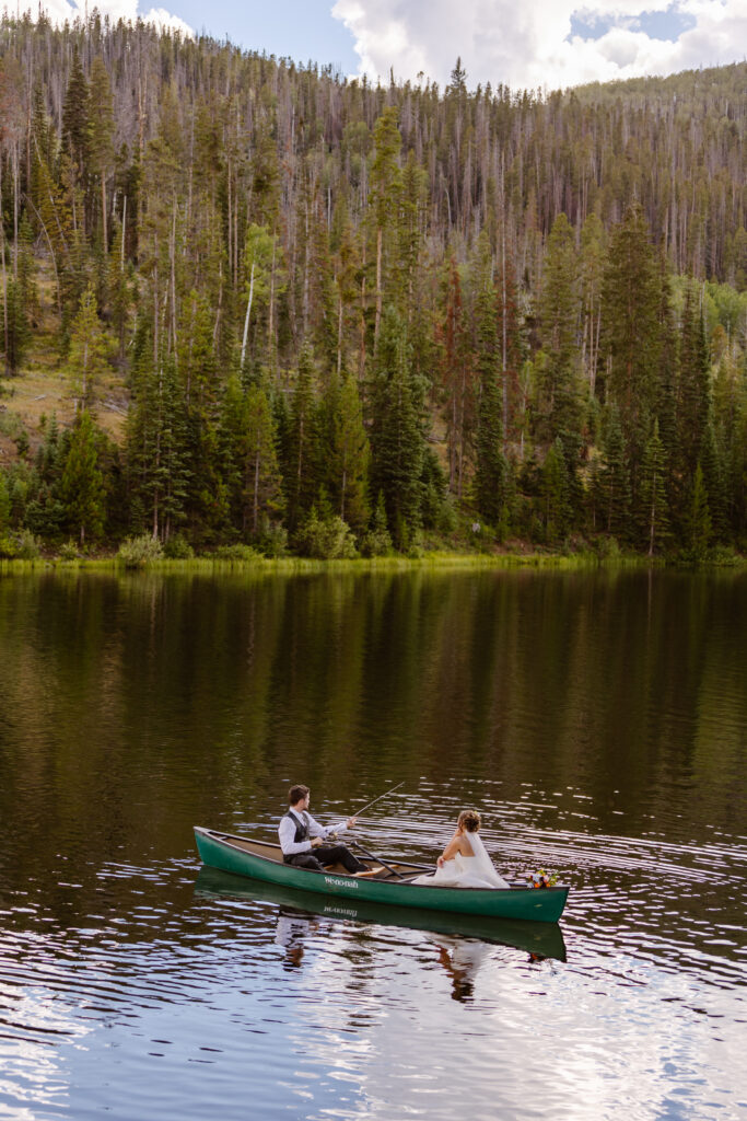 The bride and groom paddle out onto pearl lake in a canoe as an elopement day activity